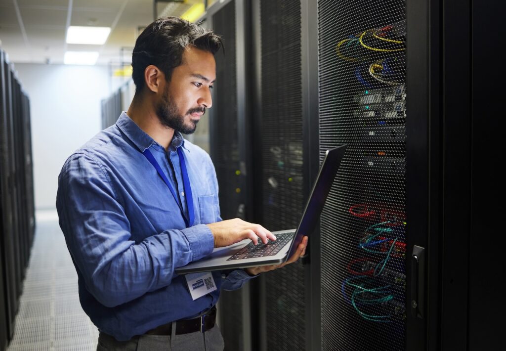 professional it services employee working in server room