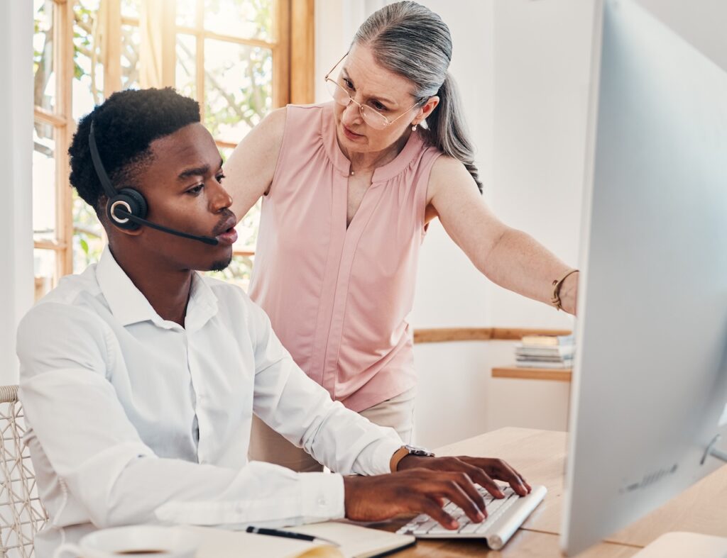 coworkers discussing tasks and client information using voip services in office