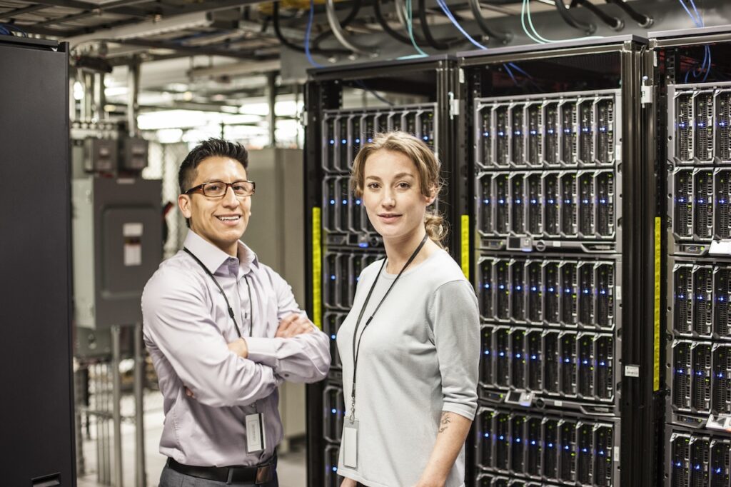 IT professionals handling managed cloud servers in server room