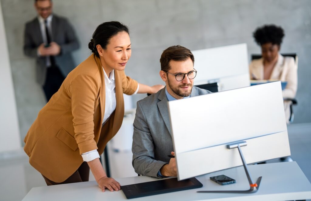 coworkers in office working on computer