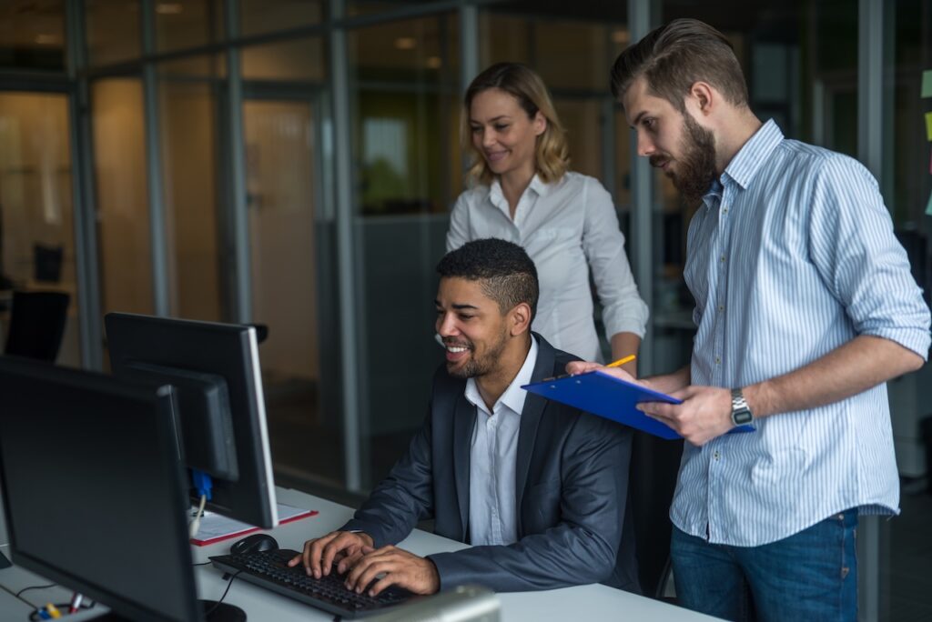 coworkers in office working on project on computer