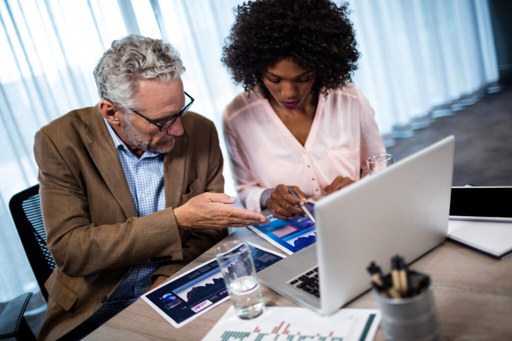 Two businesspeople working on a computer an IT services company